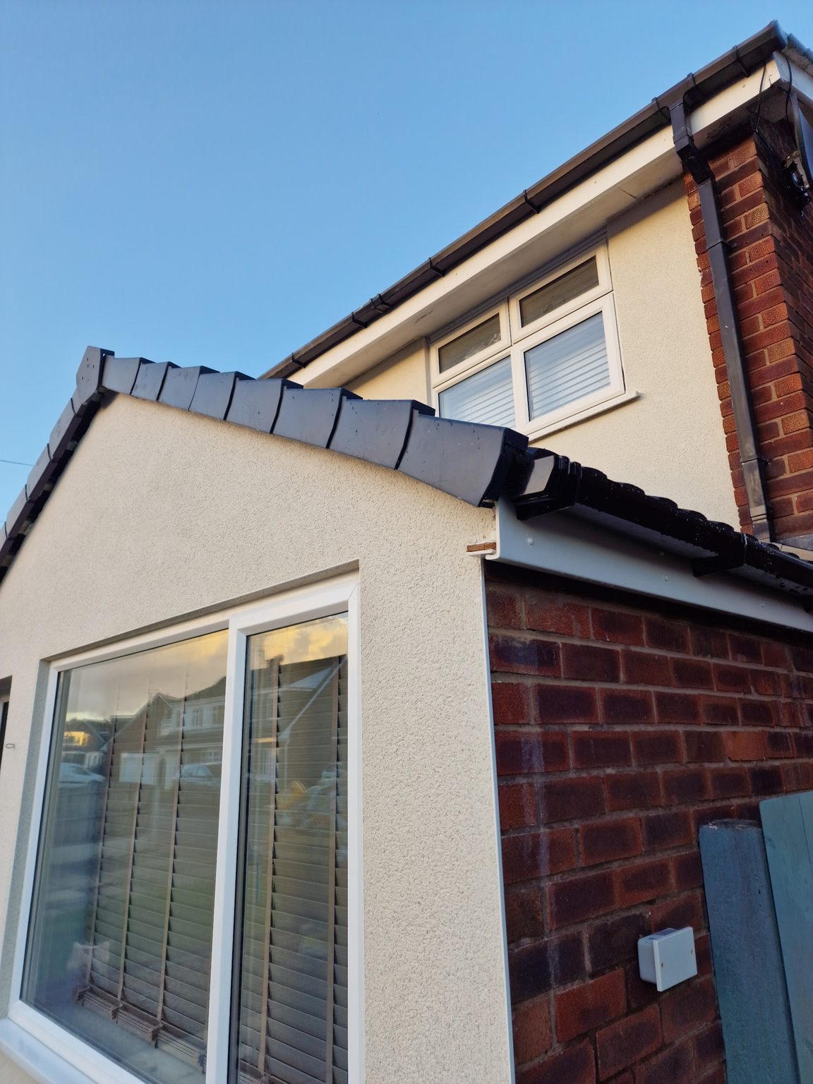 Freshly rendered extension in a smooth cream finish with a new window